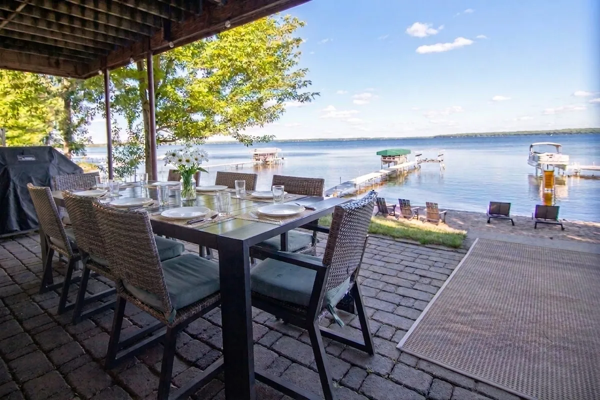 Lakeside patio dining table with chairs steps from the water